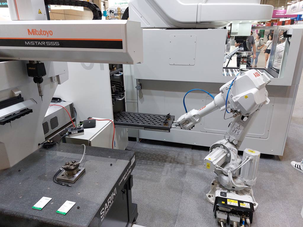 The ABB robot arm extracts one of the shelves from the SMARTPM warehouse before the part is automatically transferred to the EDM ONA IRIS machine.